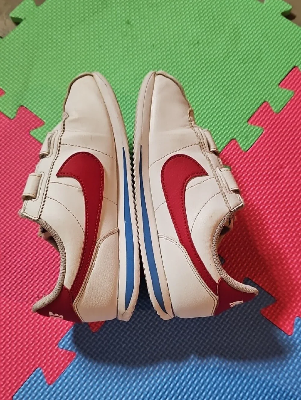Nike Kids Cream Sneakers with Red Swoosh and Blue Accent